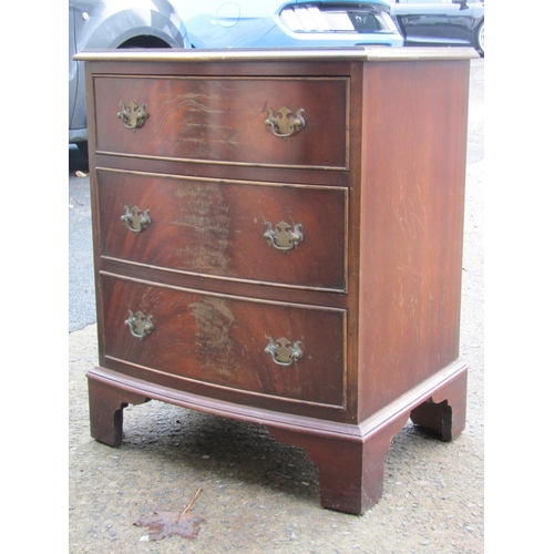 2627 - A small reproduction chest of three drawers with shallow bow fronted outline on bracket supports in ... 