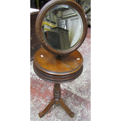 2629 - A Victorian walnut shaving stand with adjustable circular mirror raised on turned column and tripod