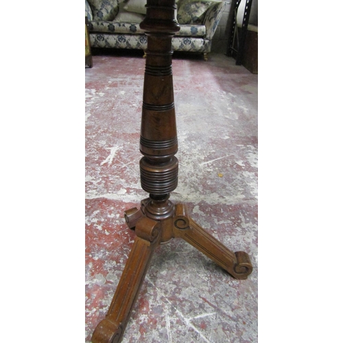 2629 - A Victorian walnut shaving stand with adjustable circular mirror raised on turned column and tripod