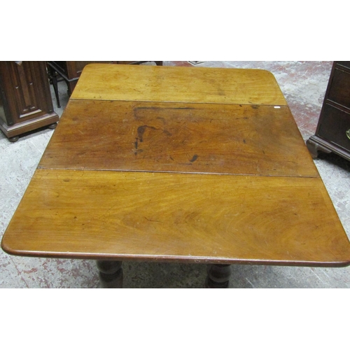 2634 - A 19th century mahogany drop leaf dining table on four turned supports, the top with swivel action t... 