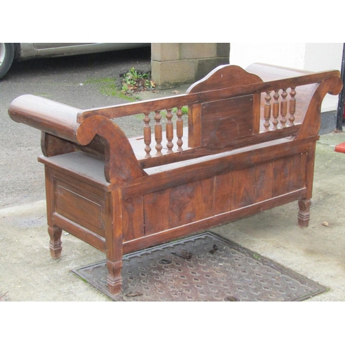 2638 - A Chinese pine settle with scrolled ends on turned spindle mouldings and carved detail, 140 cm in le... 