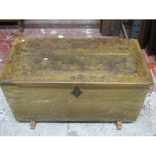 2639 - An antique oak coffer with rising lid, iron work handles and sledge feet 1metre wide