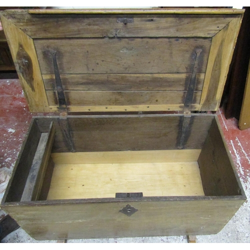 2639 - An antique oak coffer with rising lid, iron work handles and sledge feet 1metre wide