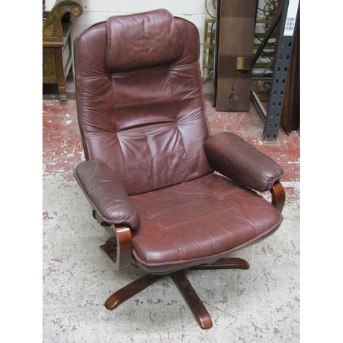 2648 - A Stressless type swivel chair in a maroon coloured upholstery on quadruped base