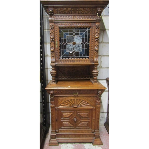 2650 - A 19th century oak pier cabinet, the lower section enclosed by a panelled door with lion mask and ot... 