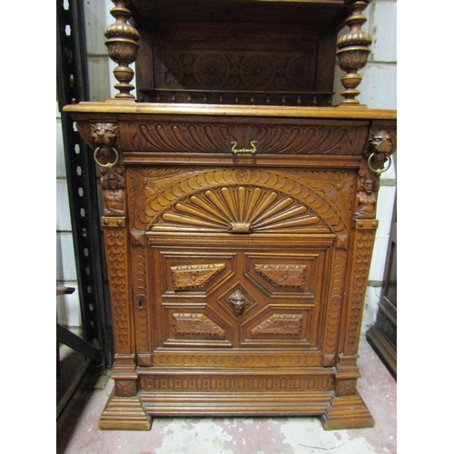 2650 - A 19th century oak pier cabinet, the lower section enclosed by a panelled door with lion mask and ot... 