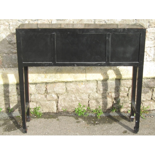 2653 - A Chinese side table with black lacquered finish enclosed by a central cupboard and four drawers on ... 