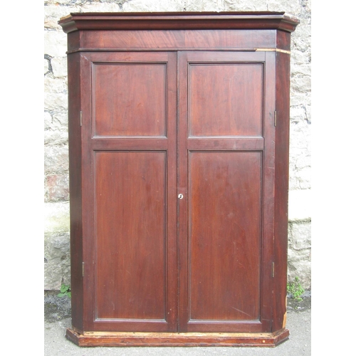 2656 - A Georgian mahogany hanging corner cupboard enclosed by a pair of panelled doors 114 cm in height