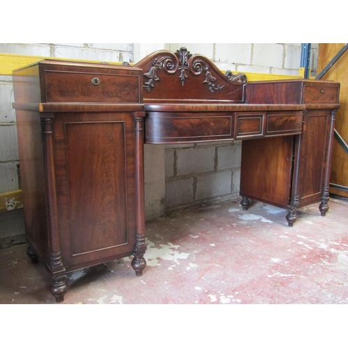 2659 - A Regency mahogany pedestal sideboard, the pedestals with panelled doors and frieze drawers, column ... 