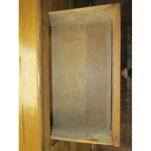 2721 - A 19th century stripped and waxed pine kitchen dresser base enclosed by three panelled doors and thr... 