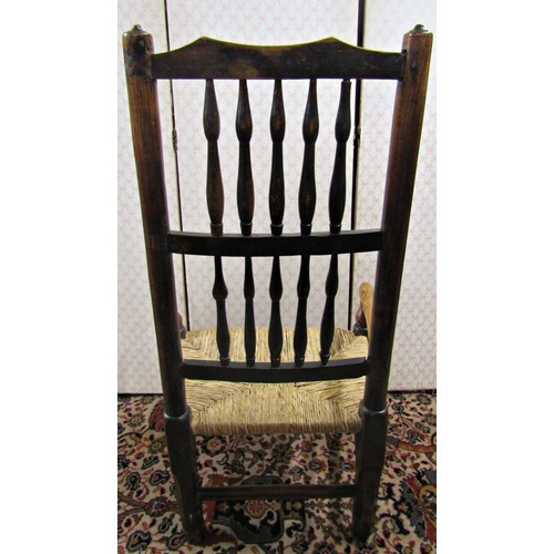 2759 - A Georgian ash wood spindle back elbow chair with rush seat on pad forelegs