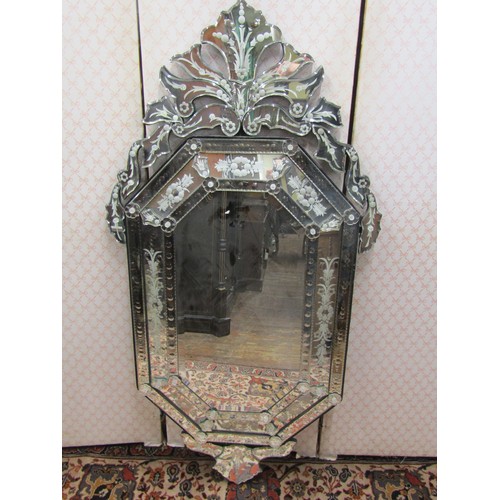 2799 - A Venetian style wall mirror the main body of elongated octagonal form with etched and cut detail, s... 