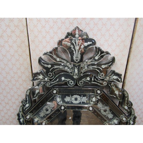 2799 - A Venetian style wall mirror the main body of elongated octagonal form with etched and cut detail, s... 