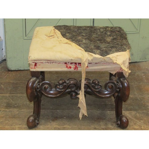 2726 - A 19th century walnut stool in the Carolean manner raised on four pronounced scrolled supports with ... 