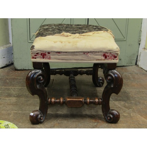 2726 - A 19th century walnut stool in the Carolean manner raised on four pronounced scrolled supports with ... 