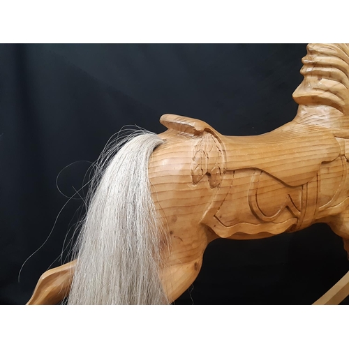 398 - Unusual carved pine rocking horse, made in Scotland 1990, with  carved mane and saddle, horsehair ta... 