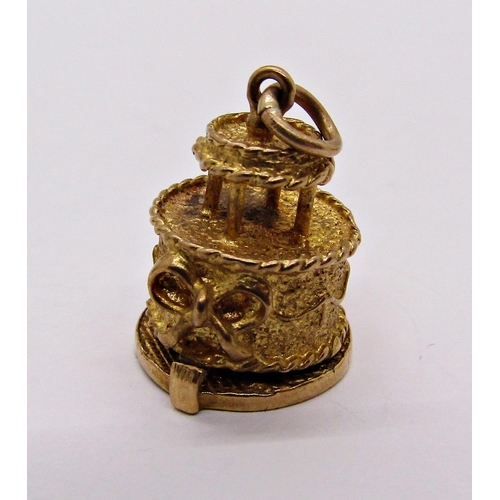 1357 - Four 9ct novelty charms comprising a hinged wedding cake with bride and groom, a lighter, coffee pot... 