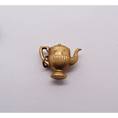 1357 - Four 9ct novelty charms comprising a hinged wedding cake with bride and groom, a lighter, coffee pot... 