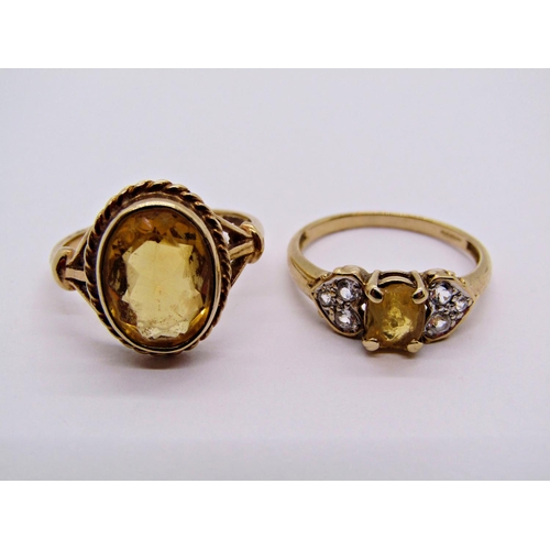 1398 - 9ct oval citrine ring, together with a further 9ct citrine ring with paste set shoulders (citrine ch... 