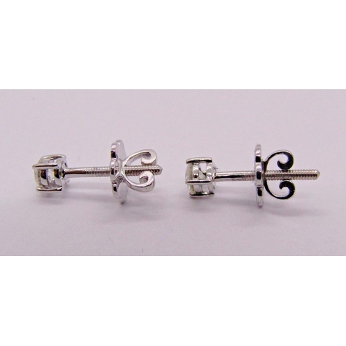 1402 - Pair of 9ct white gold diamond solitaire stud earrings with screw fastenings, each 0.15ct approx, st... 