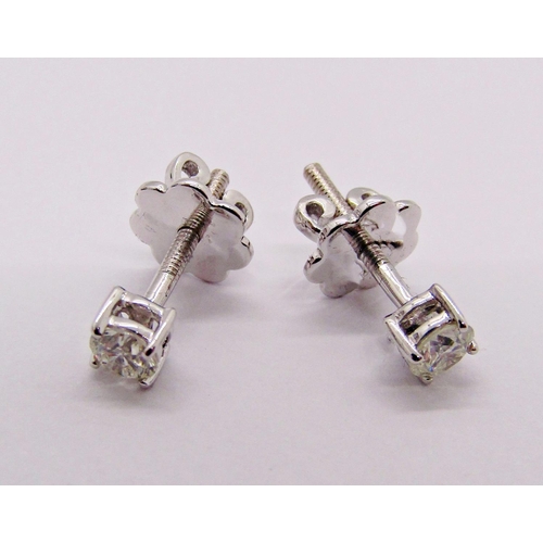 1402 - Pair of 9ct white gold diamond solitaire stud earrings with screw fastenings, each 0.15ct approx, st... 