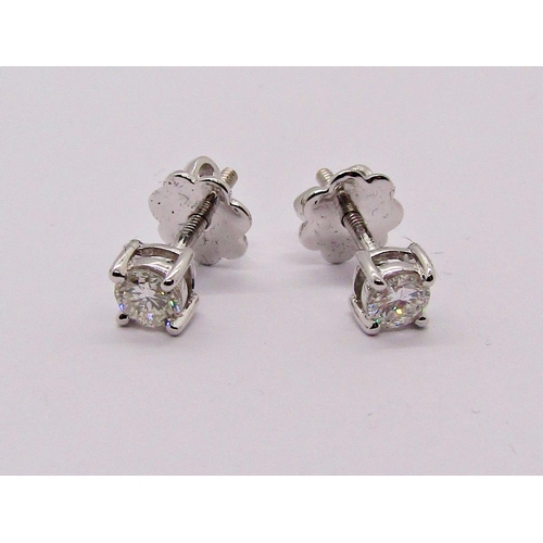 1403 - Pair of 9ct white gold diamond solitaire stud earrings with screw fastenings, 0.20ct each approx, st... 