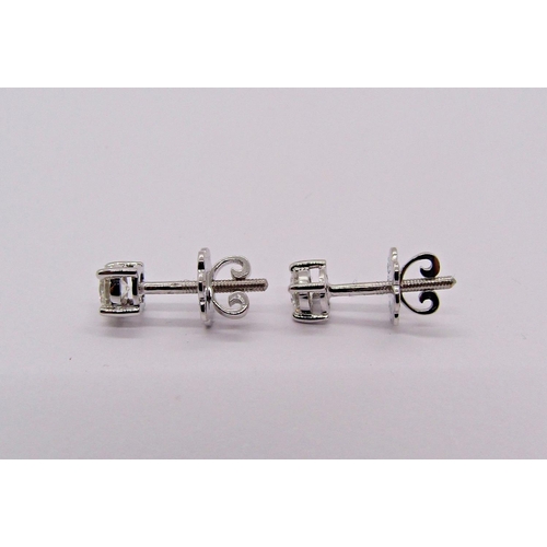 1403 - Pair of 9ct white gold diamond solitaire stud earrings with screw fastenings, 0.20ct each approx, st... 