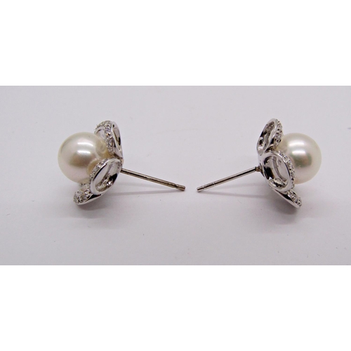 1414 - Pair of white metal floral design stud earrings set with pearls and diamonds to the petals, 5.9g (no... 