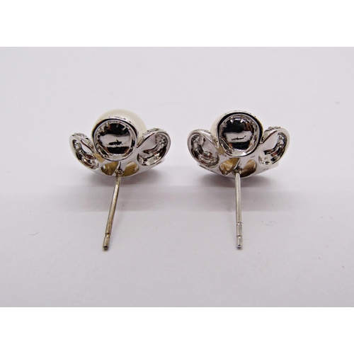 1414 - Pair of white metal floral design stud earrings set with pearls and diamonds to the petals, 5.9g (no... 