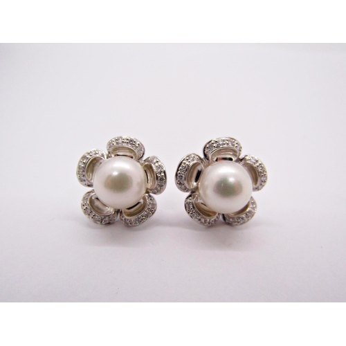 1414 - Pair of white metal floral design stud earrings set with pearls and diamonds to the petals, 5.9g (no... 