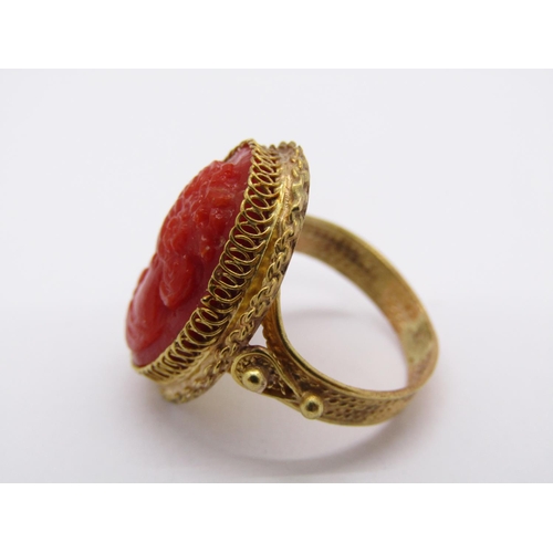 1421 - Ornate yellow metal ring set with a coral cameo depicting a lady in profile, size G, 4.9g