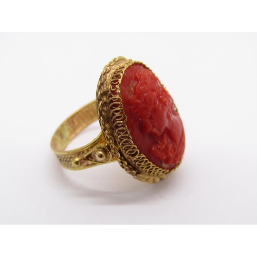 1421 - Ornate yellow metal ring set with a coral cameo depicting a lady in profile, size G, 4.9g