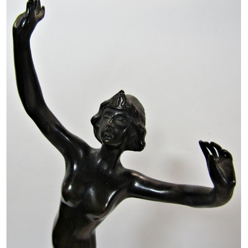 1736 - An early 20th century bronze statue of a naked female arms aloft , indistinctly signed, raised on a ... 