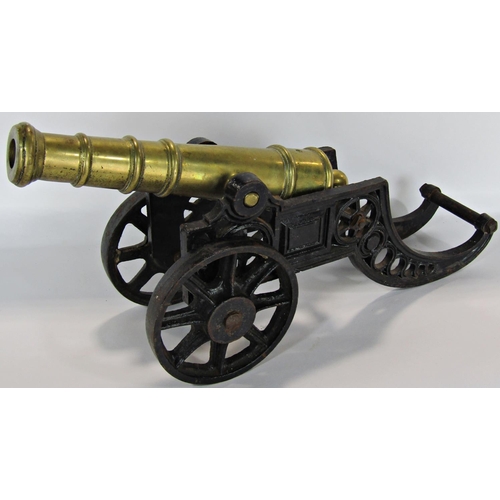 1752 - A miniature brass barrelled and cast iron field canon, a fireman's copper and brass hose nozzle, a s... 