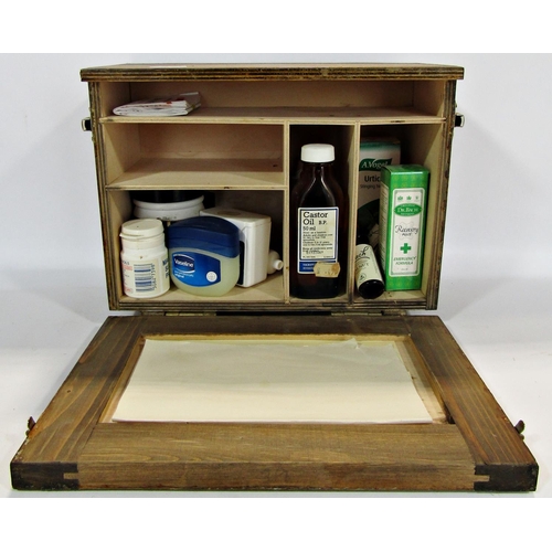 1754 - A wooden Paragon First Aid case with a fold down front containing medical items, together with a bra... 