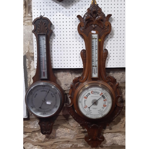 1508 - Two oak cased Aneroid barometers both with carved case work