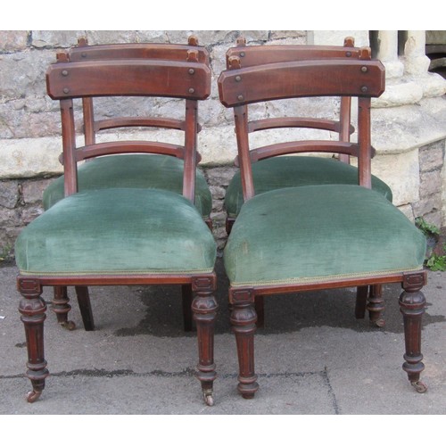 2222 - A set of four Victorian Gothic walnut dining chairs with chamfered frames, upholstered seats and tur... 