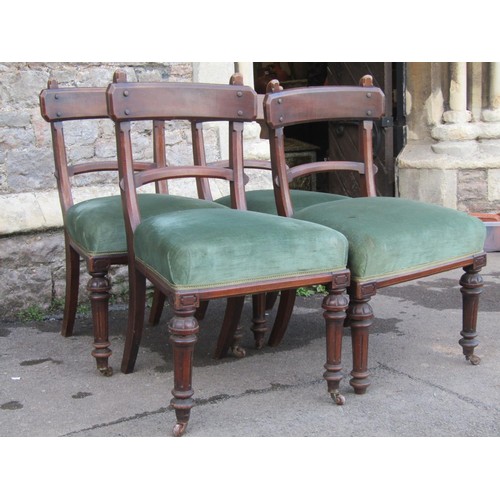 2222 - A set of four Victorian Gothic walnut dining chairs with chamfered frames, upholstered seats and tur... 