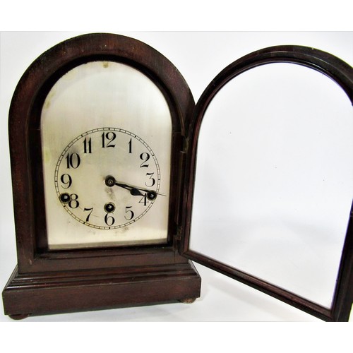 1493A - A mahogany bracket or shelf clock the domed case enclosing a German movement with silvered dial 33cm... 