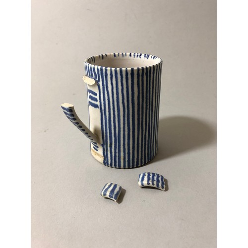 204 - Collection of mugs, saucers and a bowl to include: Sue Binn - blue stripe glazed mug; 'AM' marked mo... 