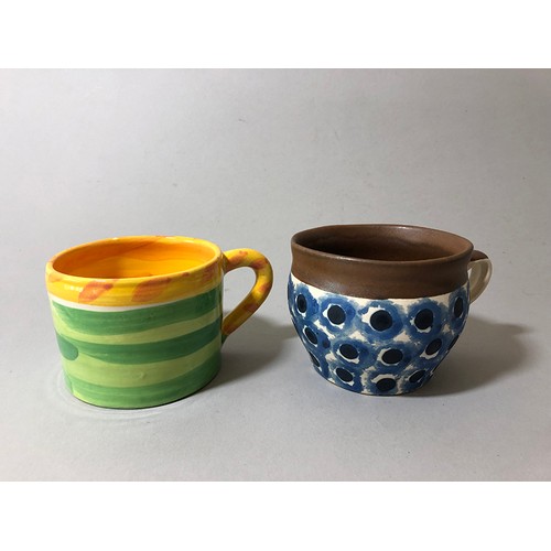 204 - Collection of mugs, saucers and a bowl to include: Sue Binn - blue stripe glazed mug; 'AM' marked mo... 