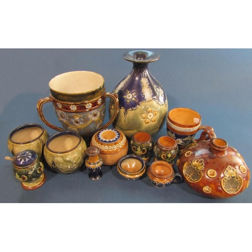 1005 - A good collection of Doulton Lambeth ware comprising a three handled loving cup with floral detail (... 