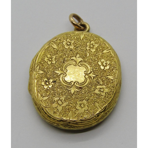 1330 - Antique yellow metal locket with belt motif and further ornately engraved decoration, 5.3g, together... 