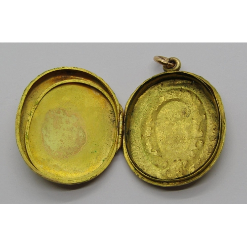 1330 - Antique yellow metal locket with belt motif and further ornately engraved decoration, 5.3g, together... 