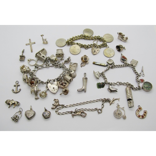 1398 - Group of three silver charm bracelets and loose charms, charms to include a Maori jade Tiki, mother ... 