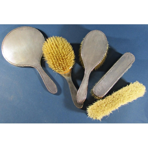 1223 - A five piece silver dressing table set comprising hand mirror, two hair brushes and two clothes brus... 