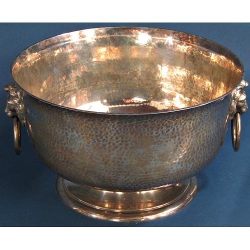 1260 - A good hammered silver presentation bowl with lion mask and ring handles raised on a turned foot 29c... 