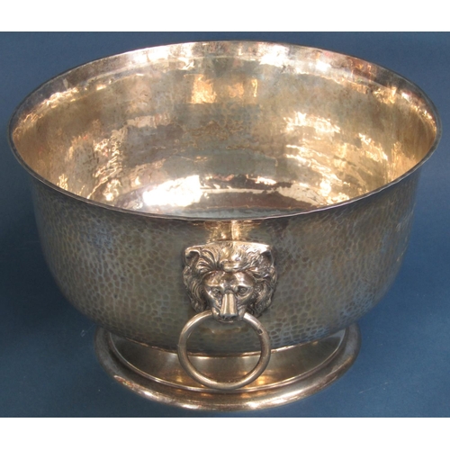 1260 - A good hammered silver presentation bowl with lion mask and ring handles raised on a turned foot 29c... 