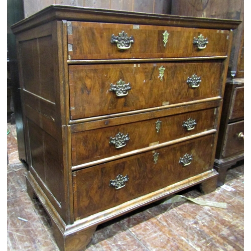 2638 - An antique countrymade chest of four long drawers, the carcass in two sections with figured walnut f... 