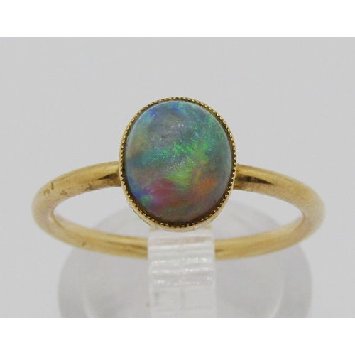 1317 - Yellow metal ring set with a cabochon opal in collet setting, size O/P, 2.4g